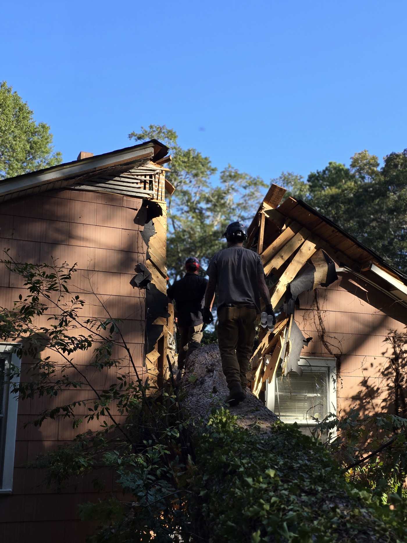 Mullinax crew on the roof of a storm-damaged house